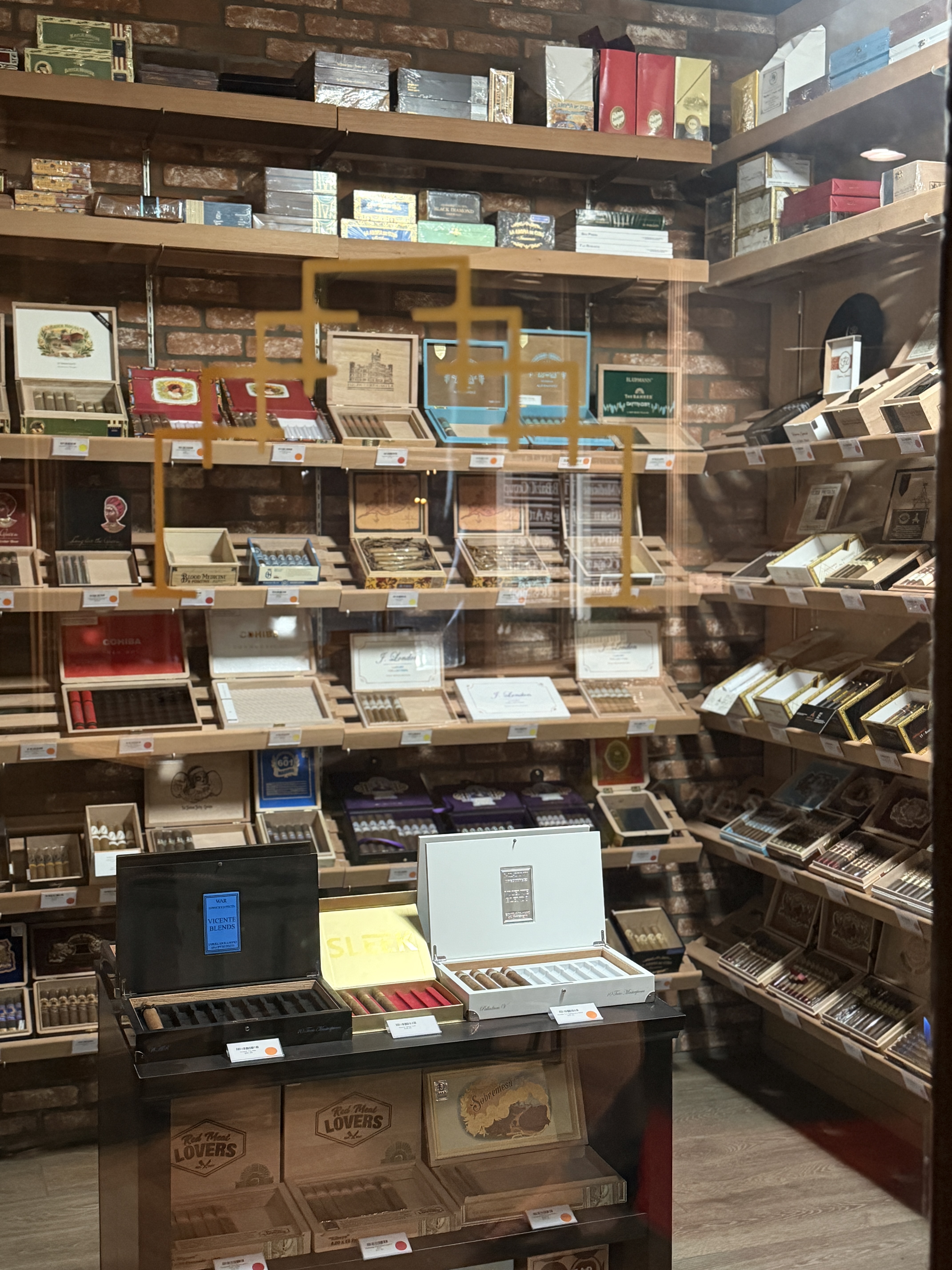 The walk-in humidor at Chartwell: brick walls lined with open cigar boxes on cedar shelves