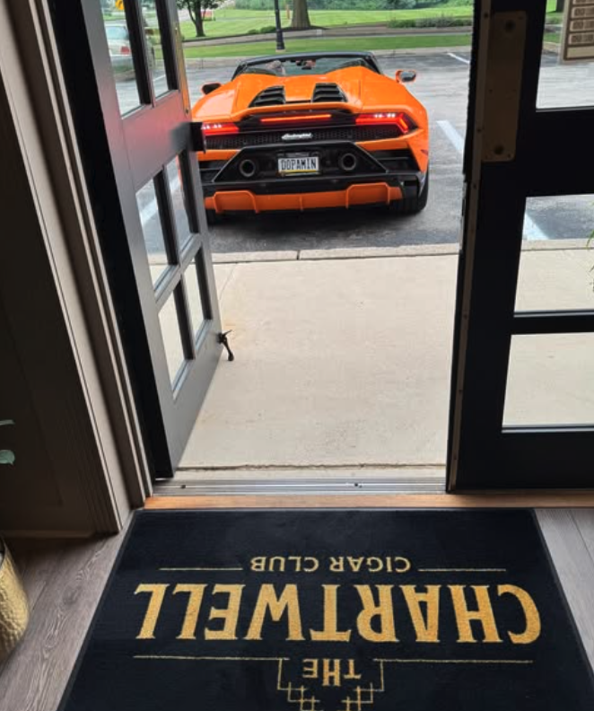 The open front door at Chartwell, looking out over the club's logo mat to the parking lot